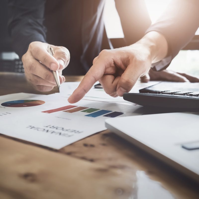 Young,Business,Man,Pointing,Graph,Chart,With,Pathner,For,Analyze